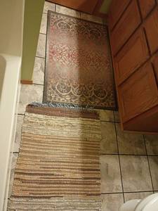 lot 929 image: Area Rugs.  46 x 30 and 41 x 27. Located in basement