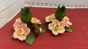 lot 1051 image: Vintage Capodimonte porcelain candle holders featuring handcrafted pink and yellow roses, green leaves, and a central bud holder.