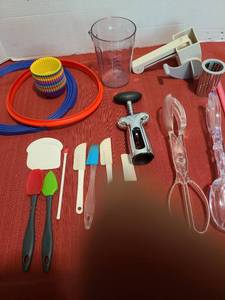 lot 1255 image: Silicone baking cups, manual cheese grater, salad tongs, corkscrew, more