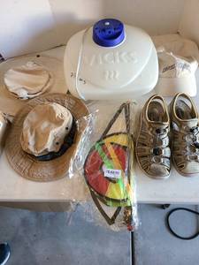 lot 3135 image: Multicolored hanging yard decor, hats, shoes, Vicks vaporizer.