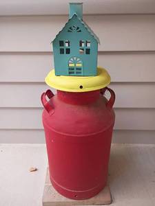 lot 955 image: Red Milk Can with Yellow Lid.  25 x 12.  Comes with small metal house