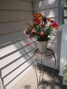 lot 965 image: Metal Plant Stand with Faux Arrangement.  Stand is 29 x 12
