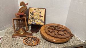 lot 1131 image: Wooden Decorative Accents Lot Alaska Theme Carved Plates Clock Figurine Lazy Susan and more