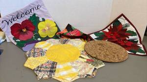 lot 1390 image: Three garden flags, two quilted place mats and a ProtectoMat