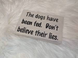 lot 3514 image: Funny Wooden Sign The dogs have been fed Dont believe their lies - Design 2