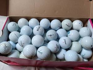 lot 33974 image: Large bag and shoe box of several different branded white golf balls