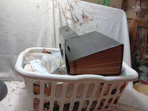 lot 33980 image: Basket full of office supplies, including a storage box with hanging file foldersdividers, staples, paper clips, envelopes, and stock cards