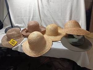 lot 33983 image: An assortment of woven straw sun hats and hat bodies with rounded domes and wide brims