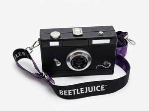 lot 63683 image: Beetlejuice Novelty 35mm Film Camera Novelty Bag w Purple Strap