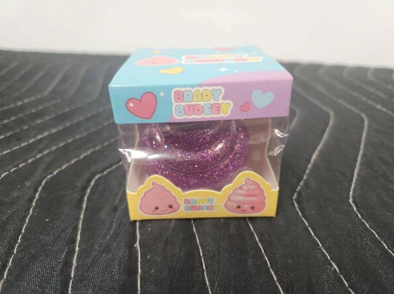 lot 63858 image: Baby Budgie Glitter Sensory Toy with Pink Poop Character