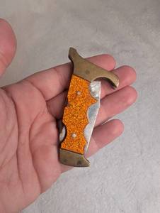 lot 1207 image: Folding Pocket Knife Orange Sparkle Handle Trigger Guard