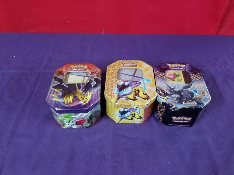 lot 2399 image: Three Tins of Pokemon Cards