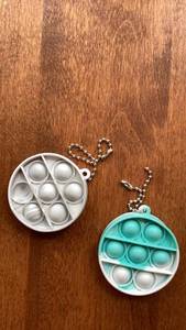 lot 206 image: Pop It Fidget Toy Keychain Round 2 Pack White Turquoise