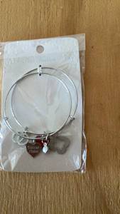 lot 344 image: Silver Bangle Bracelet with Heart and Charms