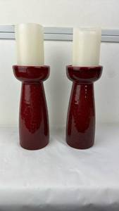 lot 113 image: Pair of Red Candle Holders with Cream Pillar Candles