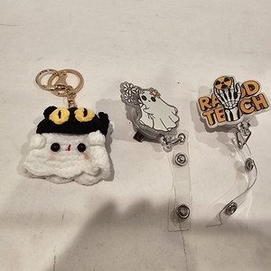 lot 2357 image: One ghost keychained and two halloween retractable reels