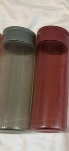 lot 44150 image: Two Cylindrical Beverage Containers with Lids Gray and Red