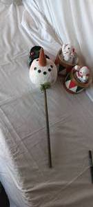 lot 34676 image: Snowman head on a decorative stick, along with a set of decorative seasonal drums with figurines sitting atop