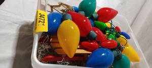lot 34721 image: Bundle of Christmas decor items, Multi colored christmas lights, wooden sled, and Gold cross