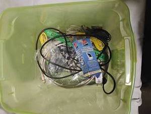 lot 34765 image: Computer cords for various connections, along with cleaning wipes for electronics