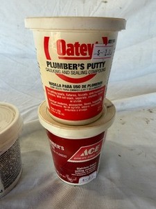 lot 34790 image: Two large tubs of plumbers putty, one tub of all-purpose spackling paste