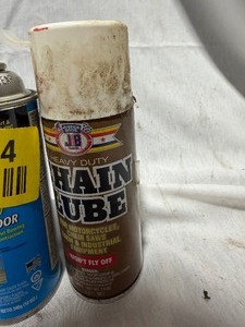 lot 34794 image: 1 can of window and door insulator, 1 can of Chain Lube