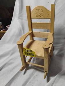 lot 34980 image: Light wood miniature rocking chair, featuring a carved heart design on the backrest