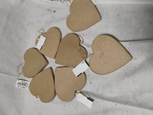 lot 35010 image: Bundle of blank heart-shaped ornaments ready to decorate