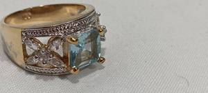 lot 35109 image: Costume jewelry ring, with a center blue stone