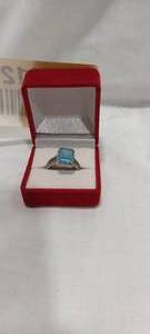 lot 35112 image: Silver ring with light blue center stone
