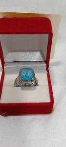 lot 35117 image: Silver costume ring with light blue center stone