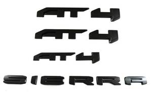 lot 2606 image: 4Pcs Kit AT4 Sierra Overlay Emblems Door Rear Car Badge Compatible with 2019-2022 Sierra 1500 2500HD 3500HD (Matte Black) - Retail $59