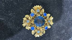 lot 69 image: Vintage Gold-tone Brooch with Blue Faceted Stone and Rhinestones