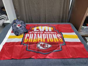 lot 675 image: Kansas City Chiefs Super Bowl LVII Champions Flag and Youth Cap Lot