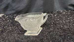 lot 46 image: Clear Glass Creamer Pitcher with Handle Ornamental Pattern