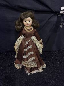 lot 50 image: Doll with Brown Dress and Lace Trim