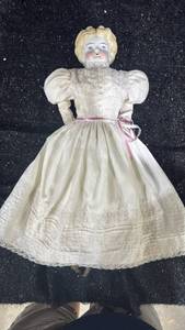 lot 51 image: Porcelain Doll with White Dress and Pink Ribbon