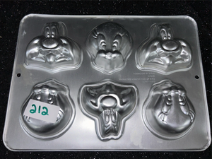 lot 212 image: Wilton Character Face Cake Pan 6-Cavity Mold