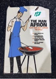 lot 1128 image: The Man Apron Grill Instructor Blue Polyester with Pockets and Bottle Opener