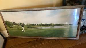 lot 1115 image: Framed Golf Course wall decor with Golfer and Water Landscape 17X38