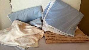 lot 1309 image: Three Sheet protector pads, a flannel sheet and a wrap up blanket