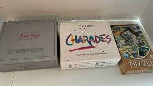 lot 2334 image: Trivial Pursuit Silver Screen Edition Card Set, Charades and Wonders of the World 500pc Puzzle