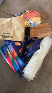 lot 2342 image: Shelf liner pieces, rags, and reusable bag and fabric