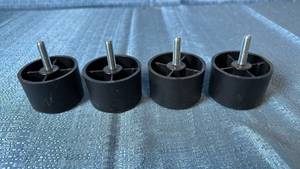 lot 2125 image: Lot of 4 Round Black Plastic Furniture Legs.