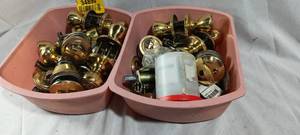 lot 34890 image: Two tubs full of gold-tone door locks and knobs