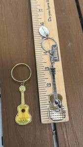 lot 23 image: Disney Pixar Coco Guitar Keychain & Unbranded Guitar Keychain (Lot of 2)