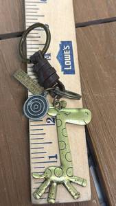 lot 114 image: Keychain with Giraffe Charm, Concentric Circle Pendant, and Wrapped Cord
