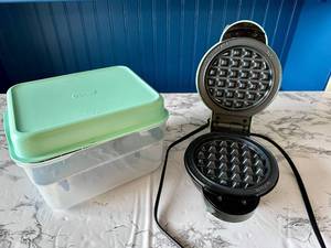 lot 111 image: Dash Mini Waffle Maker with 7 Interchangeable Plates and Storage Container - Retail $30