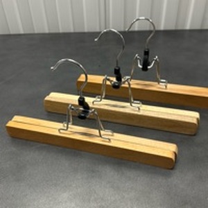 lot 31 image: Wood Pants Hangers with Metal Clips Set of 3