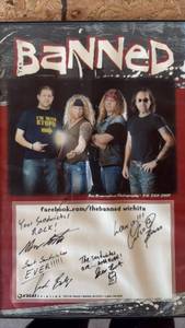 lot 128 image: The Banned Band Framed Autographed Poster approximately 11 by 17 inches